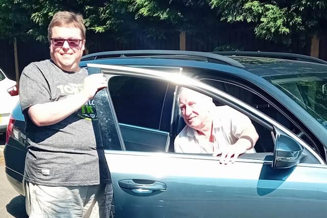 Andrew, one of the volunteer drivers for the transport scheme pictured with service user Adam. Photo: Submitted