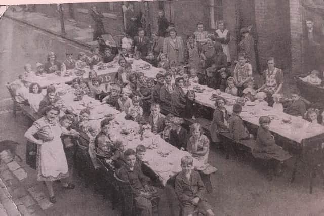 VE Day street party 1945, on Gedling Street in Mansfield. Pictured is Mary Mousley's mother, Harriet Summers, standing on the left, alone with Mary and her sister,  Betty.