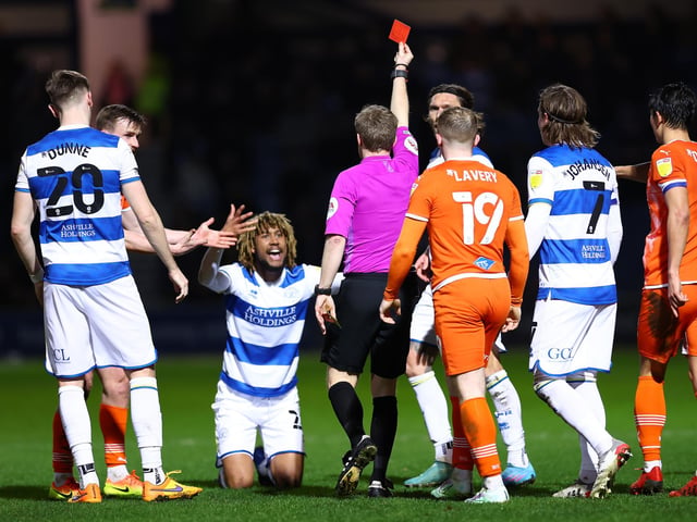 Dion Sanderson of Queens Park Rangers receives a red card from Gavin Ward against Blackpool.