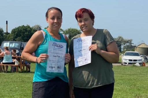 Lyndsey and twin sister Leanne with their certificates after completing the skydive.