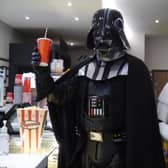 Darth Vader and a Stormtrooper stock up on treats during the Star Wars fan event