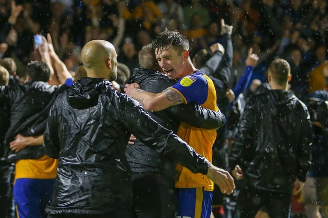 Mansfield Town defender Oli Hawkins celebrates at the end.