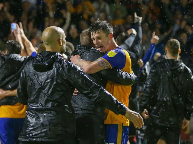 Mansfield Town defender Oli Hawkins celebrates at the end.