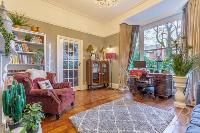 The living room is also distinguished by its grand bay window, which overlooks the front of the house, by its decorative coving, feature picture-rail and wooden flooring.