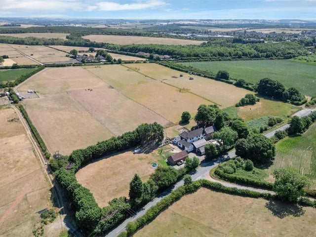 A substantial seven bedroom, six bath/shower room, detached farmhouse bordering to open countryside set in just over 3 acres, together with a substantial range of traditional outbuildings offering considerable potential, in all extending to circa 8,525 sq ft.