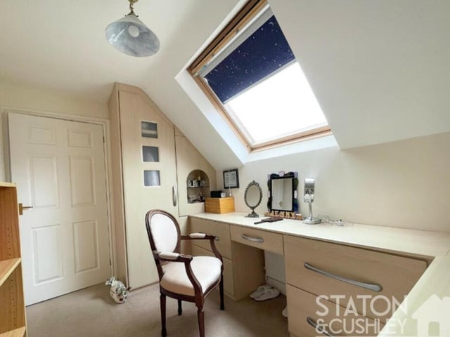 This is the dressing room that attaches itself to the master bedroom. A double-glazed Velux window faces the front of the property.