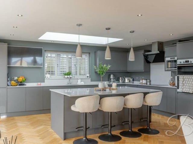 At the heart of the kitchen is a modern quartz centre island with breakfast bar that is lit up by a skylight and beautifully framed by three feature pendant lights.There is also space and plumbing for an American fridge freezer.