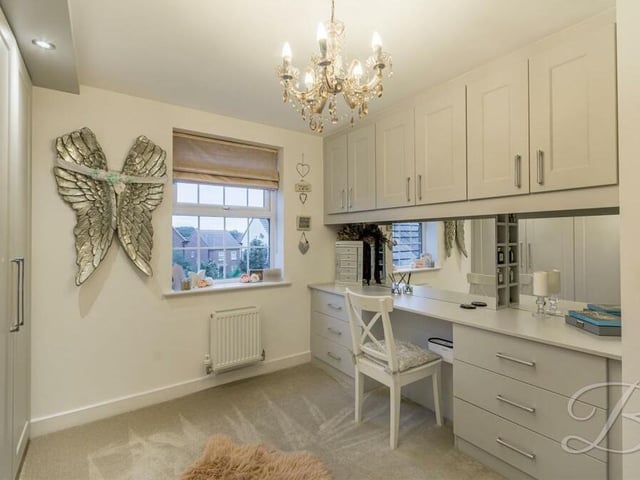This bedroom, complete with storage space and wardrobes, could be used as a dressing room.
