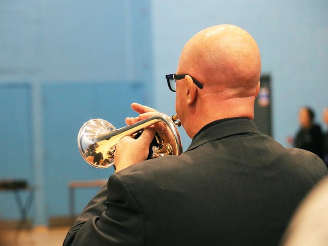 Former army musician and member of college staff Mike Kilmartin played the bugle