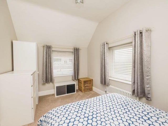 Here is the fourth and final bedroom, with windows to the side and rear of the property.
