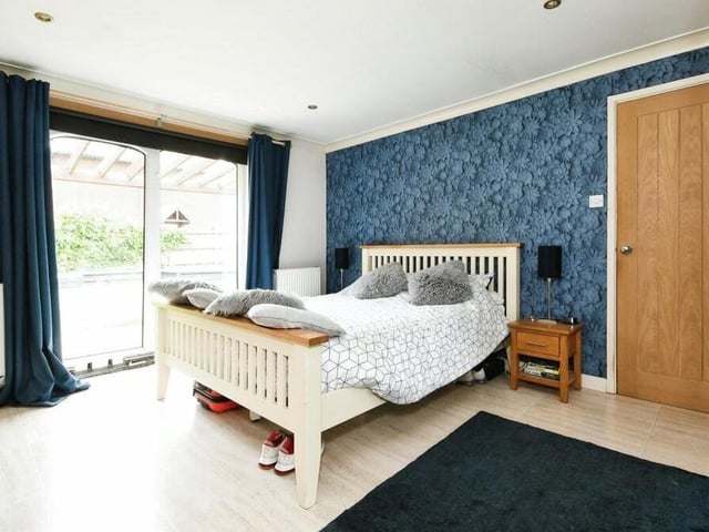 Here is the first of the three double bedrooms within the Fern Street bungalow. It is a very attractive master with doors to the garden and access to en suite luxury.