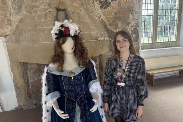 Tyler Turner is pictured next a model who shows how Margaret Cavendish would have dressed.