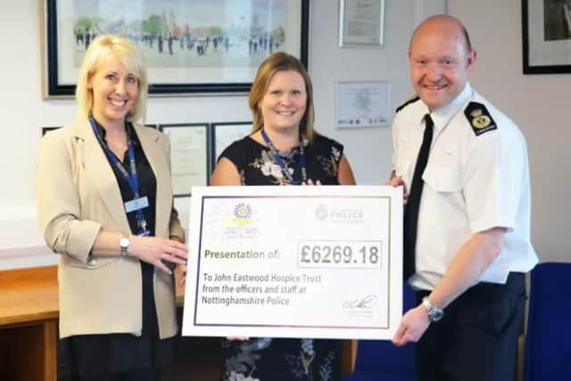 Chief Constable Craig Guildford presents a cheque to Lisa Todd, left, and Tracey Joyce from John Eastwood Hospice.