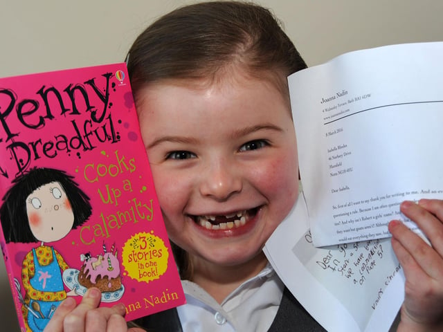 Isabella Rhodes with her signed book, reply letter and a copy of the letter that sparked an internet sensation after she wrote to author Joanna Nadin in 2016.