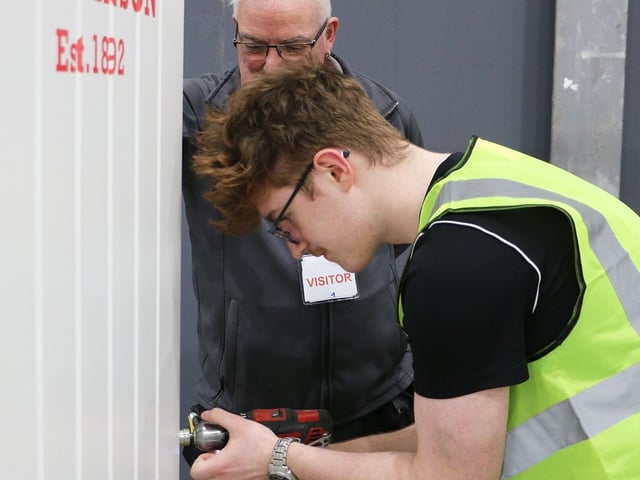 Tomlinson let groups get hands-on with door hanging