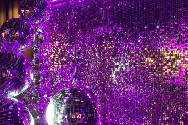 A glamorous sparkling backdrop for the show created by All Things Decor.
