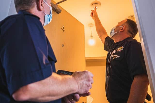 Fitting a smoke alarm - Nottinghamshire Fire and Rescue Service urge people to check their smoke alarms regularly