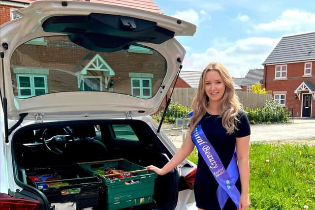Beauty queen Nikita Wilson with a car boot full of items she collected for the Kirkby Storehouse foodbank.