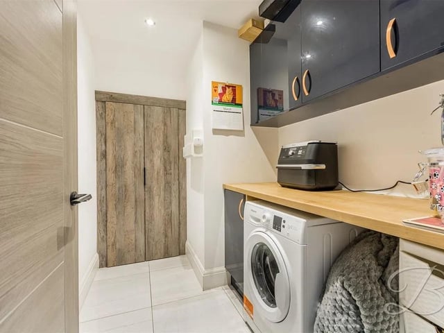 The property benefits from a utility with tiled flooring, complete with a range of modern gloss units and cabinets with complementary work surface over. With space and plumbing for a range of appliances.