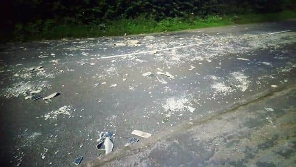 Fly tipping spread across the road by vehicles.