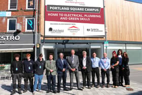 Plumbing and electrical installation students join Andrew Cropley MBE (sixth, left), Coun Matthew Relf (fifth, left), Benjamin Ekpenyong from the Ministry of Housing, Communities and Local Government (fourth, left), Gavin Peake (sixth, right), Andrew Stevens (fifth, right), and Darren Atkins (fourth, right) at the new Portland Square campus. Photo: Submitted