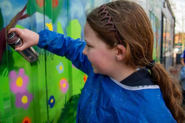 Year 6 pupil working on the mural.