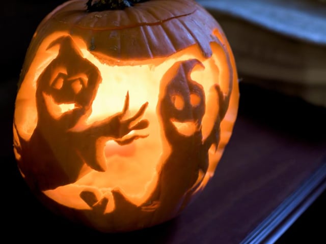 Instead of turning your pumpkin into a character, why not use it to design a scene, like these spooky looking ghosts.