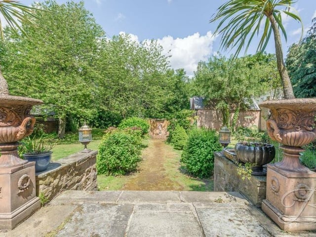 The garden is full of character and charm. From the patio area, steps lead down to the lawns.