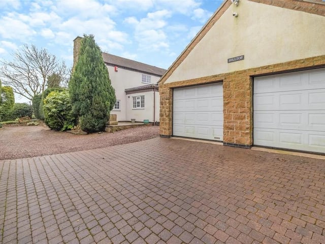 Hill Top occupies a large plot extending to circa 0.34 of an acre and is set back and well screened from Brick Kiln Lane behind tall conifer boundary frontage. There is an in-and-out driveway entrance which leads onto an extensive gravelled and block paved driveway and to a substantial detached double garage equipped with power and light.