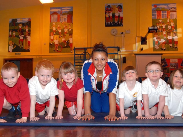 Great Britain Gymnastics team member Becky Downie helps Foundation stage children from the Northfield Primary School with their press-ups during a visit back in 2011.