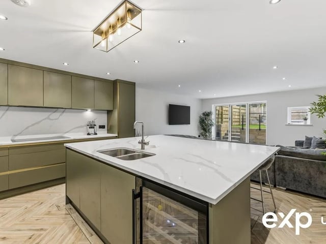 A vast, free-flowing, modern living/dining kitchen, this seamless open-plan space will be fitted with the buyer's choice of kitchen from the sellers' range. Please refer to the images that illustrate a recommended design of a modern, usable, high-end kitchen with ample storage solutions and a fabulous oversized central island seating area.