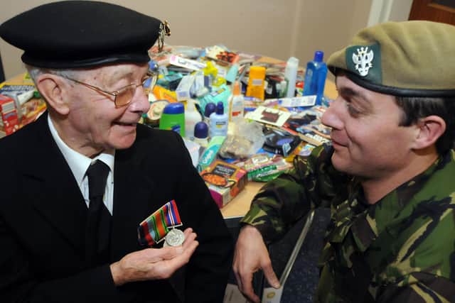 Rotarian and WW2 Vetran Gordon Sugg speaking to Major Chris Massingham about his medals at a special presentation of gifts for serving soldiers from the Kirkby Rotary club