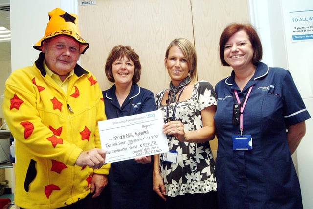 'Crazy' Dave Townsend presented a cheque for £521.23 raised by a charity auction and car boot sale to staff at King's Mill Hospital in 2007.  Pictured (left to right) are: fundraiser Dave Townsend from Sutton-in-Ashfield, Wendy Coles, Macmillan Clinical Nurse Leader at the Welcome Treatment Centre, and midwives Jane Sheldon and Maria Curtis.