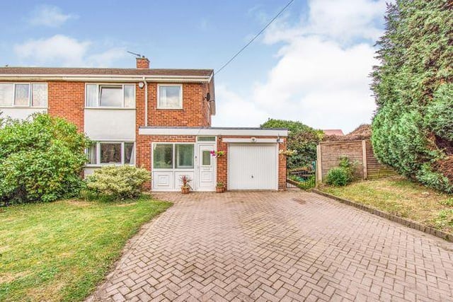 This three bedroom house has a brick constructed conservatory with tiled flooring and a ceiling fan.
