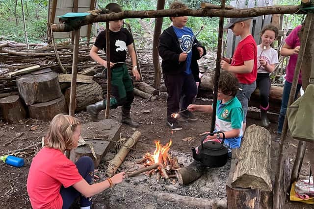 Youngsters busy in front of an open fire at one of the Rika Bushcraft sessions.