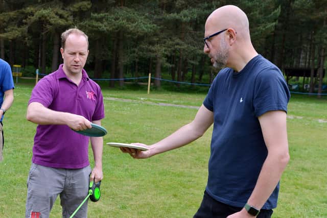 Chad editor Ashley Booker receives advice from Richard Hatton, owner Disc Golf UK.