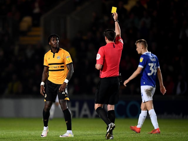 Adebayo Azeez receives a yellow card. Newport had 67 bookings and three reds.