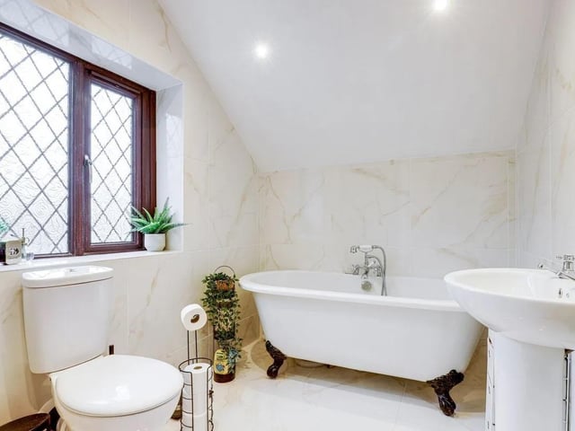 Enjoy a soak in the freestanding roll top double-ended bath with a hand-held shower in the luxury family bathroom.