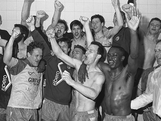 Stags players celebrate their last day success in the dressing room.