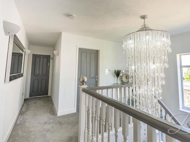 Once upstairs, you are greeted by this welcoming landing, featuring a carpeted floor, underfloor heating and wall lights.