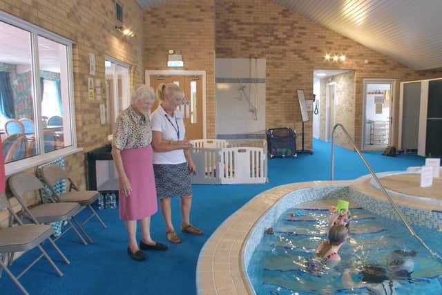 An Ashmere Notts Residents enjoying watching her Great Grandchildren in the onsite swimming pool.