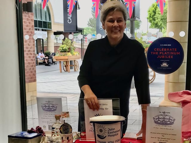 A supporter mans a fundraising stall.