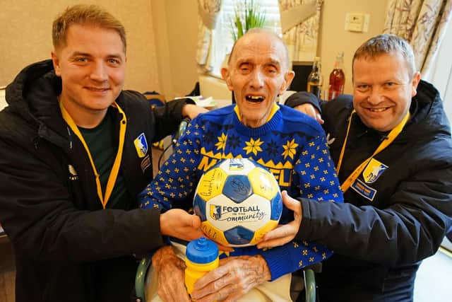 Keith Painter with Michal Kasinowicz and Gary Shaw from Mansfield Town Community Trust at Berry Hill Park care home.