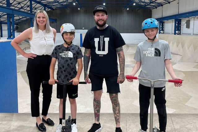 Sophie Cherry from Persimmon Homes Nottingham presents £1,000 of Building Futures funding to Asylum Academy for Extreme Sports owner Jack Plowman and some of the club’s members.