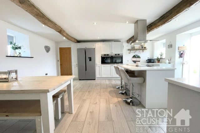 Ceiling beams, a tiled floor and underfloor heating are all features of the kitchen/diner, which has plenty of space for a breakfast or dining table.