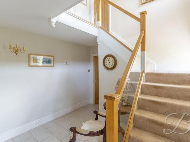 It's time to check out the first floor, so let's pass through the entrance hall and take the carpeted staircase.