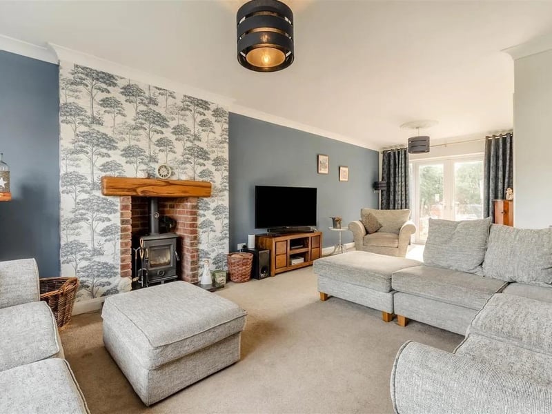 The beautifully appointed lounge boasts a brick fireplace with multi fuel stove set on a granite hearth with oak mantle above with French doors leading out onto the south facing rear garden.