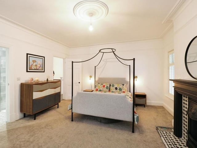 The characterful master bedroom is so typical of the way the renovation contains a nod or two to the property's Edwardian roots. A feature fireplace adds to the room's style and personality.