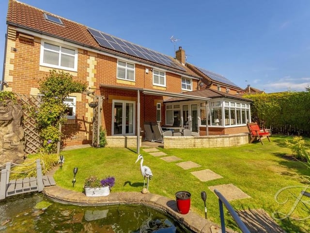 A handful of exterior photos conclude our tour of the £350,000-plus Sutton house, starting with this lovely view of the back of the property. As you can see, the conservatory leads to a patio area and then out into a beautiful garden, complete with lawn and exquisite pond.
