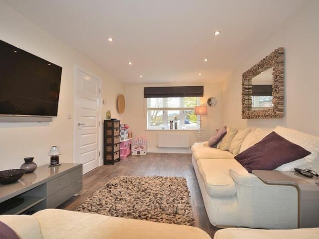 The ground floor boasts two generously-sized reception rooms, including this large but cosy lounge. With windows at either end, it is filled with natural light.
